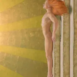 A man with long red hair is hanging on the wall.