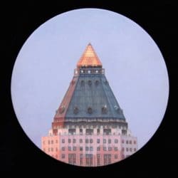 A view of the top of a building from a telescope.