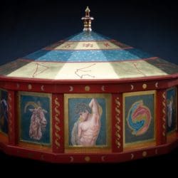 A painted carousel with various images of people.